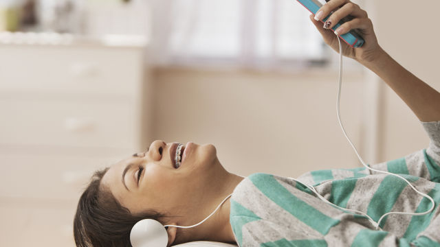 Garota com fones de ouvido ouvindo música